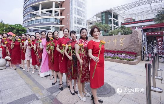 6月7日一早，廈門雙十中學(xué)考生家長(zhǎng)們身穿旗袍，手拿向日葵在考場(chǎng)外為孩子加油打氣，寓意“旗開(kāi)得勝，一舉奪魁”。人民網(wǎng)記者 陳博攝