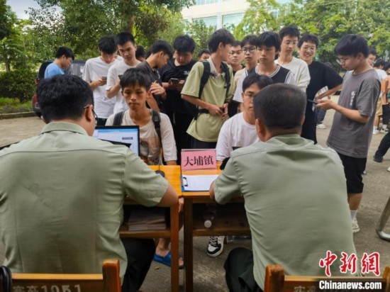 專武干部在發(fā)放兵役登記證。韋碩 攝