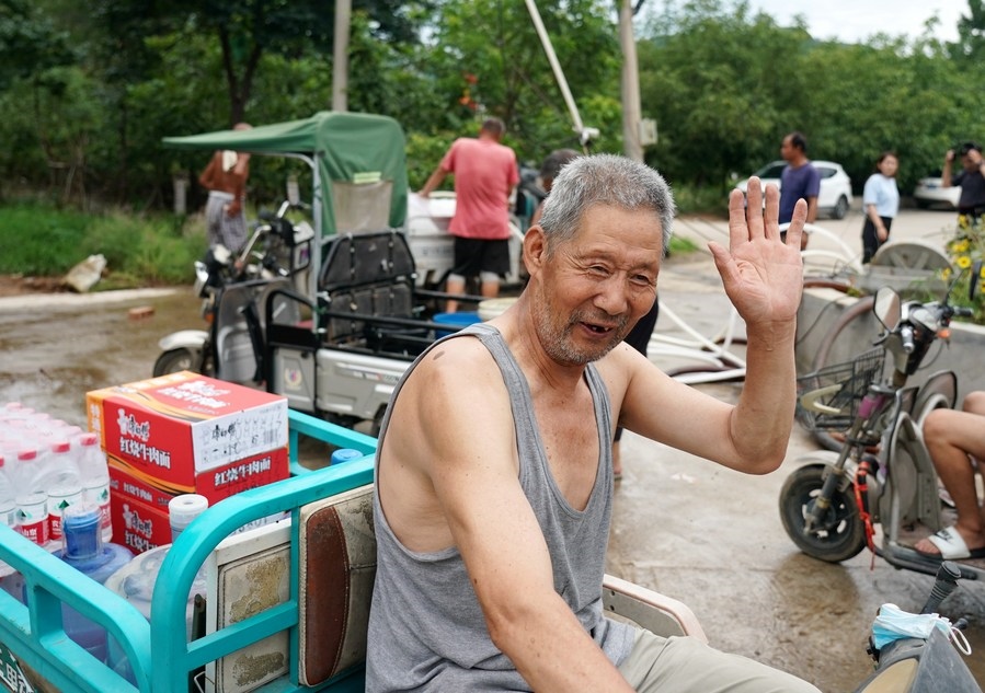 8月5日，從安置點回來的北京市房山區(qū)青龍湖鎮(zhèn)口頭村村民高大爺領(lǐng)到生活物資準(zhǔn)備回家。新華社記者 張晨霖 攝