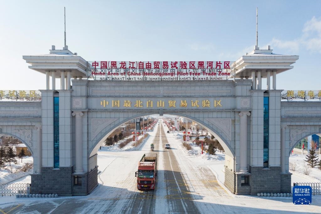 2月11日，車輛駛出中國(guó)（黑龍江）自由貿(mào)易試驗(yàn)區(qū)黑河片區(qū)大門（無(wú)人機(jī)照片）。新華社記者 謝劍飛 攝
