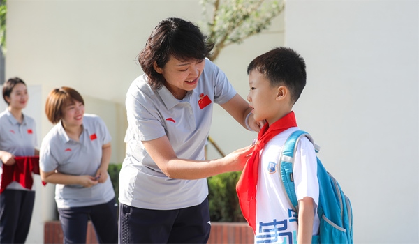 8月30日，雄安史家胡同小學(xué)學(xué)生體驗學(xué)校生活。老師為學(xué)生佩戴?；铡? /></p> <p style=