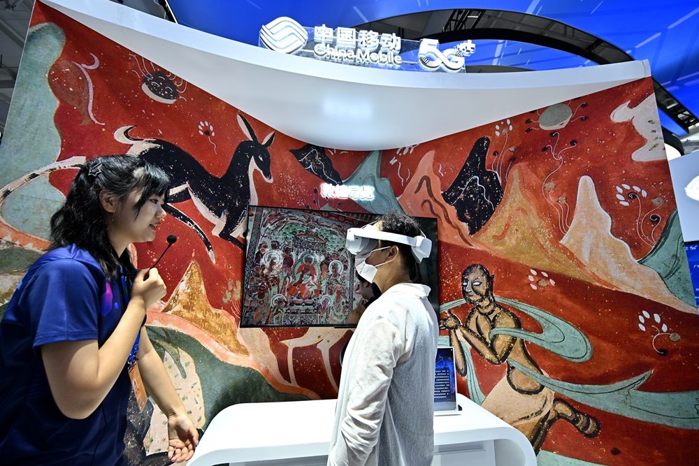 9月3日，一名參觀者在首鋼園中國移動(dòng)展臺(tái)體驗(yàn)基于AR/VR特效的敦煌導(dǎo)覽，沉浸式感受敦煌壁畫的魅力。新華社記者 李鑫 攝