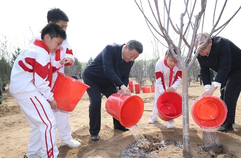 2024年4月3日，習(xí)近平總書(shū)記同少先隊(duì)員一起給剛栽下的樹(shù)苗澆水。