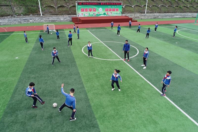 陜西安康平利縣老縣鎮(zhèn)中心小學的學生在操場上踢球。
