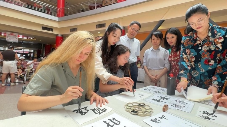 羅馬尼亞友人在活動現(xiàn)場學(xué)寫漢字。中國駐羅馬尼亞大使館領(lǐng)僑處供圖