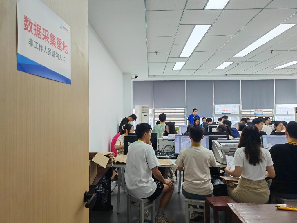6月13日，在重慶市西南大學(xué)評卷點(diǎn)，工作人員正在進(jìn)行試卷掃描工作。新華社記者 周思宇 攝
