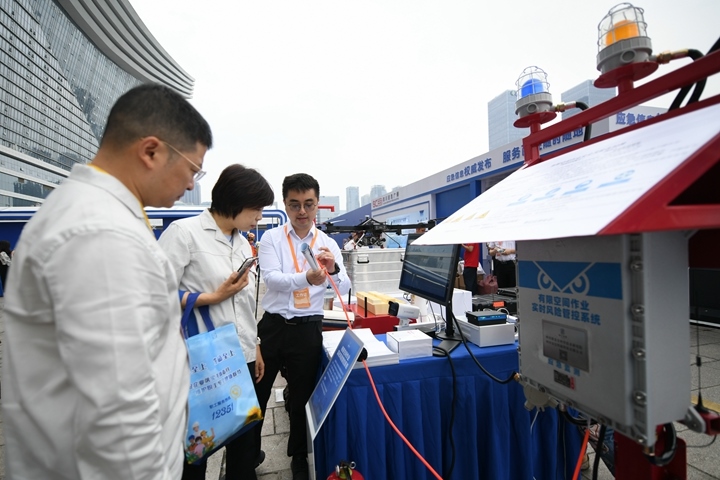 6月16日，在全國“安全宣傳咨詢?nèi)铡敝鲌龌顒由?，四川省安全科學(xué)技術(shù)研究院工作人員（右一）向參觀者介紹“有限空間作業(yè)實時風險管控系統(tǒng)”。新華社記者胥冰潔攝