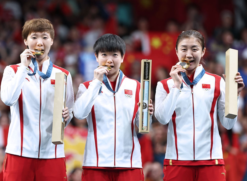 冠軍中國(guó)隊(duì)選手王曼昱、孫穎莎、陳夢(mèng)（從左至右）在巴黎奧運(yùn)會(huì)乒乓球女子團(tuán)體頒獎(jiǎng)儀式上（2024年8月10日攝）。新華社記者 王東震 攝