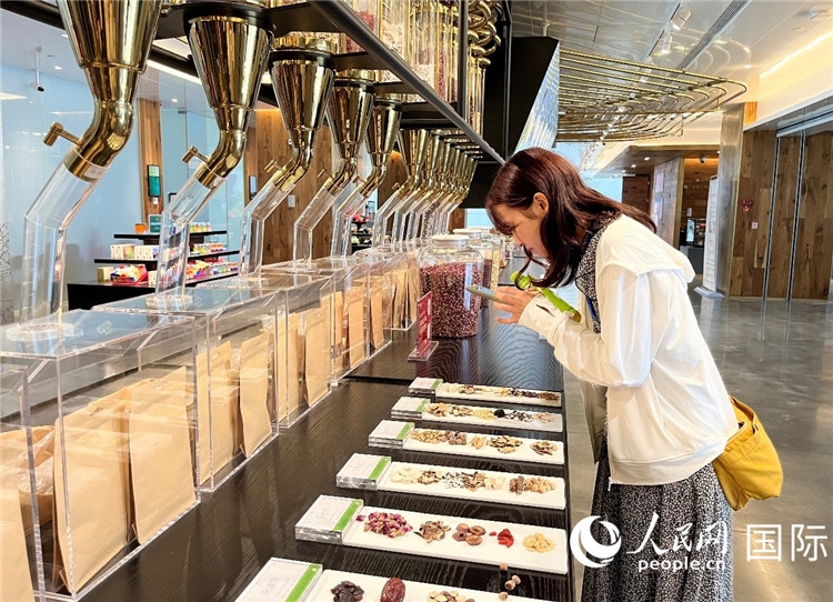 4. 代表團(tuán)團(tuán)員對新中式茶飲的食材充滿興趣。（人民網(wǎng)記者陳思 攝）