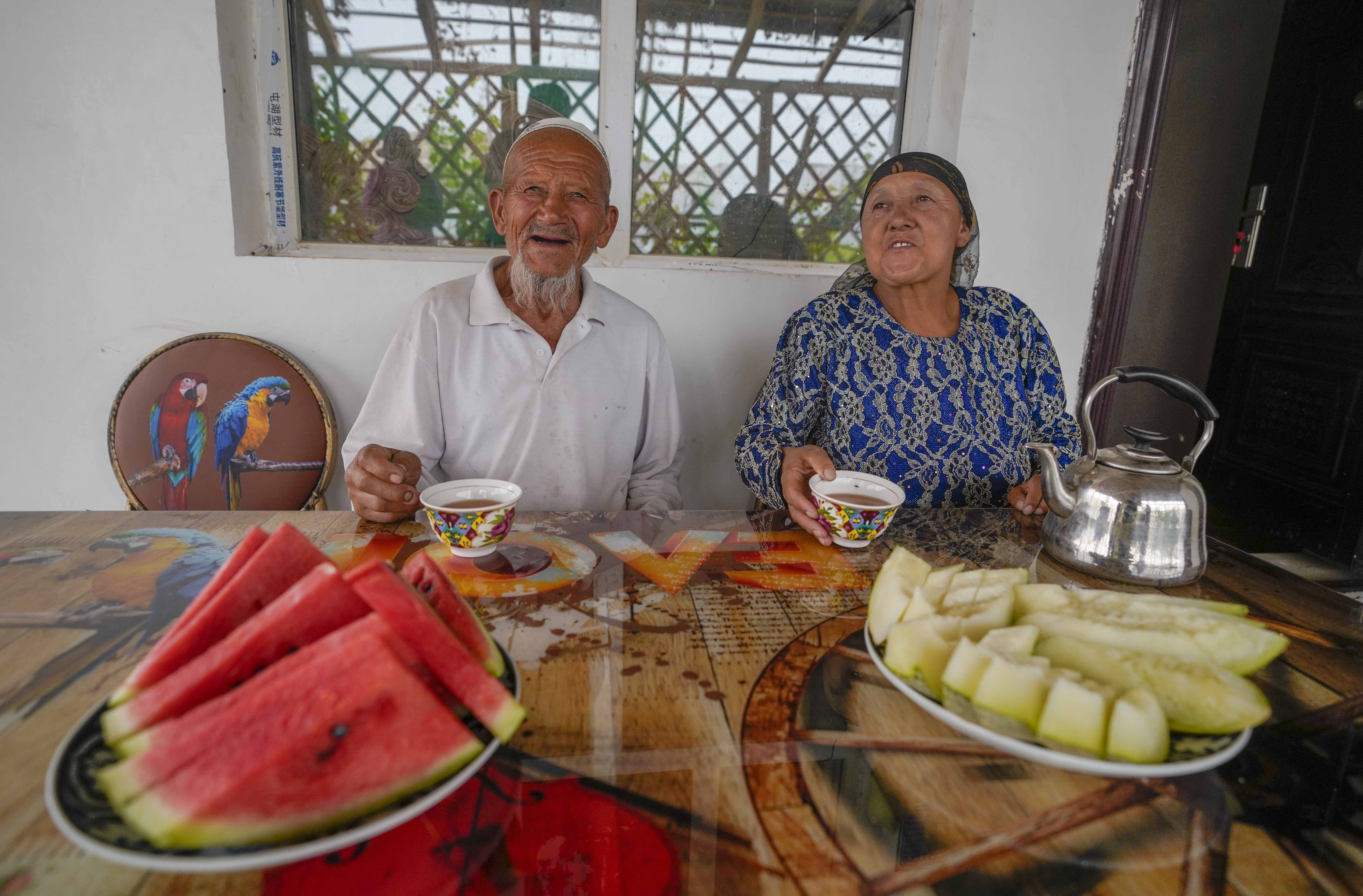 在新疆喀什地區(qū)伽師縣江巴孜鄉(xiāng)依帕克其村57號，80歲的維吾爾族老人伊米提·艾山（左）在自家庭院中（2020年6月8日攝）。